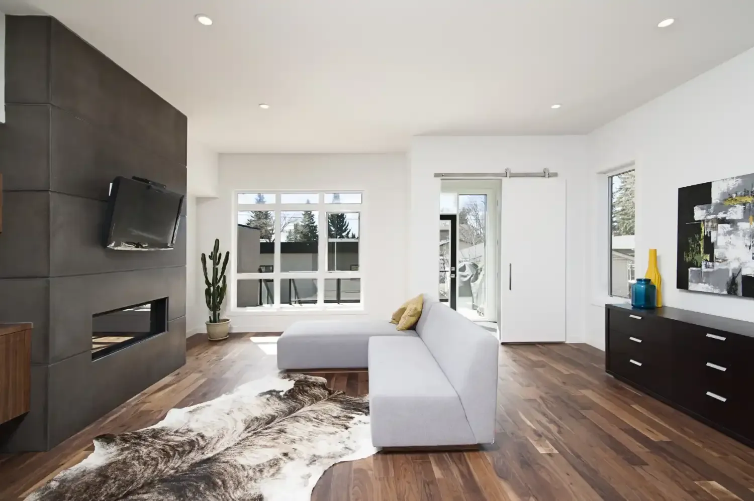 A living room with a couch , rug , fireplace and television.
